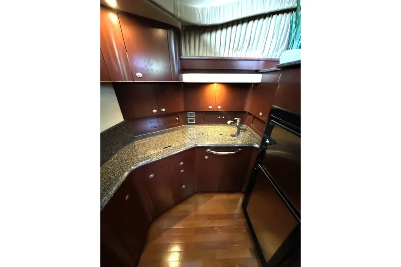  Yacht Photos Pics Luxurious 2007 Sea Ray 40 Motor Yacht kitchen with sleek wood cabinetry and granite countertops.