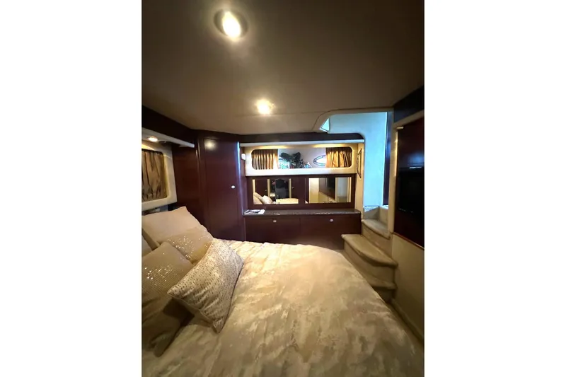  Yacht Photos Pics Luxurious interior of 2007 Sea Ray 40 Motor Yacht with elegant bedding and ambient lighting.