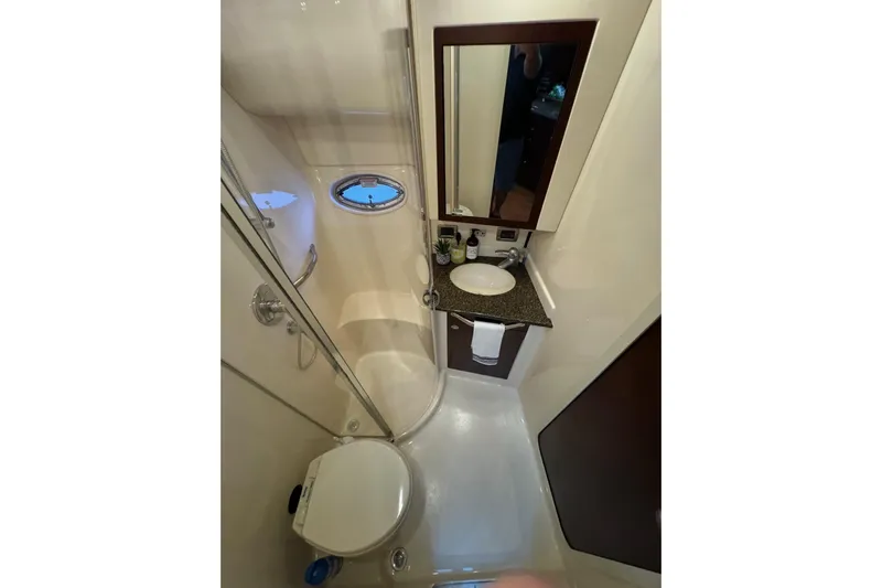  Yacht Photos Pics Bathroom interior of 2007 Sea Ray 40 Motor Yacht with shower, sink, and porthole window.