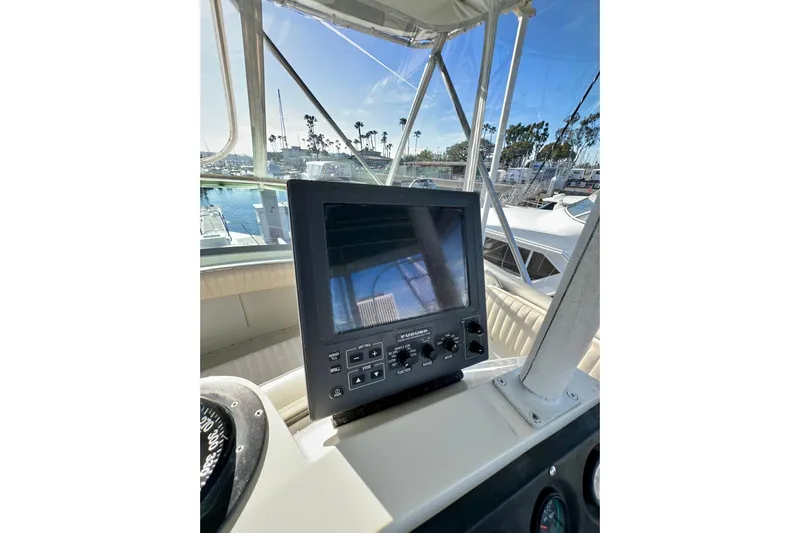 Live Wire Yacht Photos Pics Control panel of a 1982 Bertram 46 Convertible yacht with marina view.