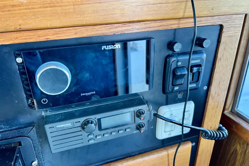 Live Wire Yacht Photos Pics Control panel of a 1982 Bertram 46 Convertible boat with radio and switches.