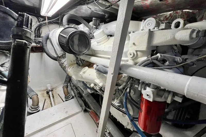 Live Wire Yacht Photos Pics Engine room of a 1982 Bertram 46 Convertible yacht, showcasing mechanical components.