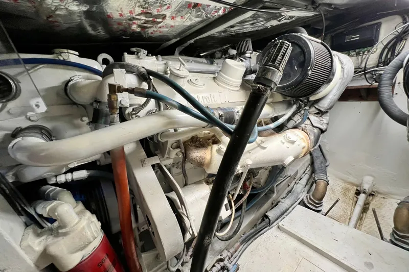 Live Wire Yacht Photos Pics Engine room of a 1982 Bertram 46 Convertible boat, showcasing detailed machinery.
