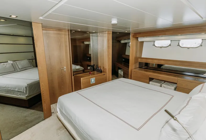  Yacht Photos Pics Luxurious bedroom interior of 2009 Sanlorenzo SL72 yacht with elegant wood finishes.
