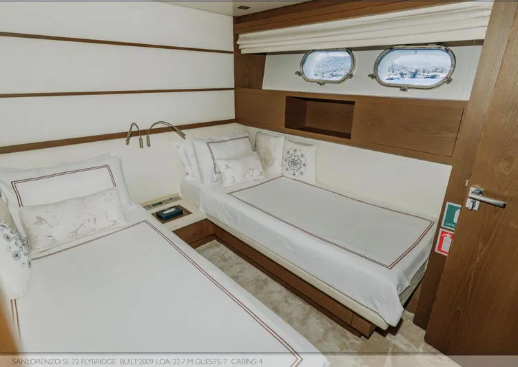 Yacht Photos Pics Luxurious twin cabin interior on 2009 Sanlorenzo SL72 yacht, featuring elegant bedding and porthole windows.