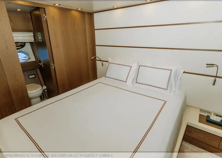  Yacht Photos Pics Luxurious cabin interior of 2009 Sanlorenzo SL72 yacht with elegant bedding and wooden accents.