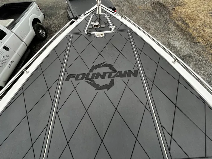 Steelin Time III Yacht Photos Pics 2011 Fountain 38 CC Tournament Edition boat deck with logo, featuring diamond-patterned design.