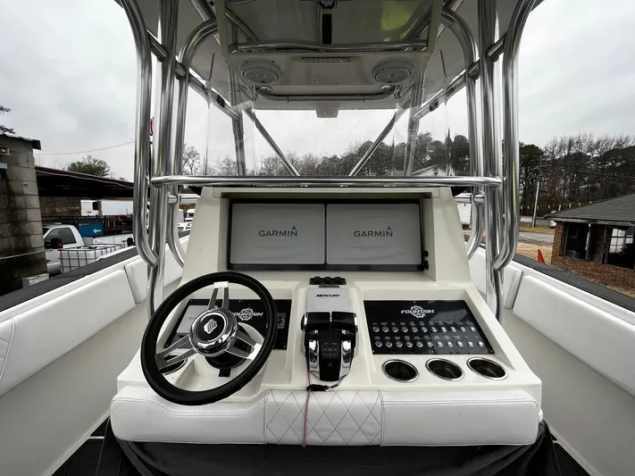 Steelin Time III Yacht Photos Pics 2011 Fountain 38 CC Tournament Edition boat console with Garmin displays and steering wheel.