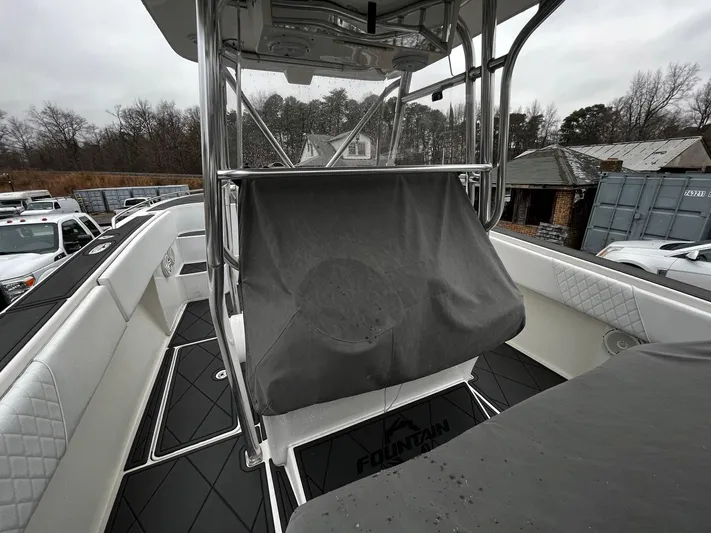 Steelin Time III Yacht Photos Pics 2011 Fountain 38 CC Tournament Edition boat interior with covered console, parked outdoors.