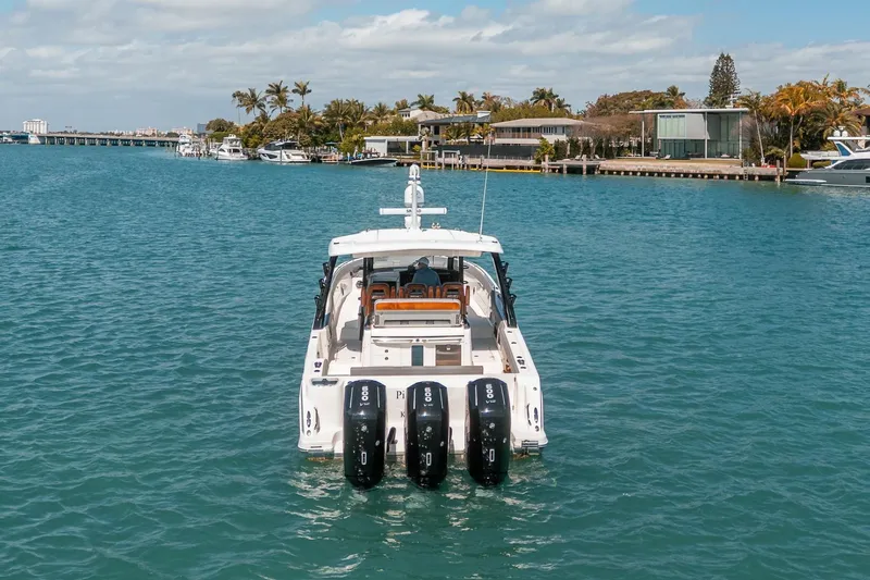 Pipe Dream Yacht Photos Pics 2023 Boston Whaler 420 Outrage on serene water with scenic coastal backdrop.