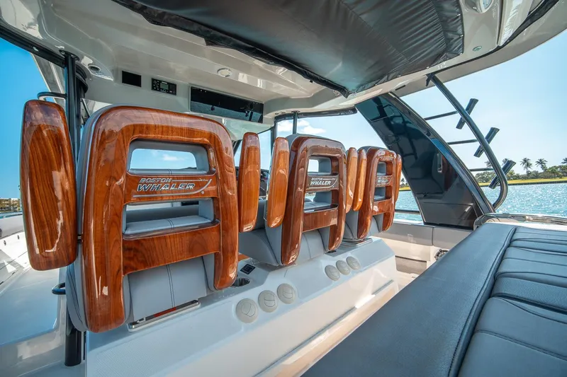 Pipe Dream Yacht Photos Pics 2023 Boston Whaler 420 Outrage interior with luxurious seating and wood accents.