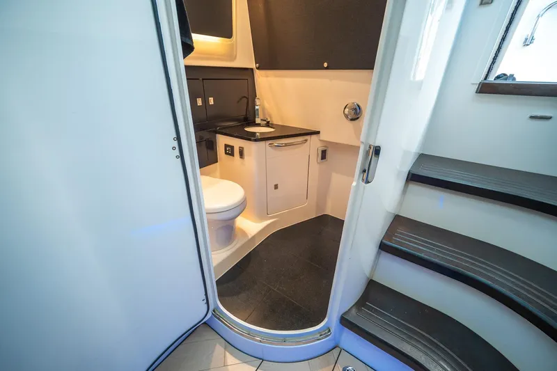 Pipe Dream Yacht Photos Pics 2023 Boston Whaler 420 Outrage interior bathroom with modern fixtures and sleek design.