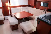 Interior of 2017 Hanse 455 yacht with cozy seating and modern kitchen area.