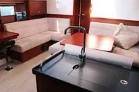 Luxurious interior of 2017 Hanse 455 yacht with modern kitchen and cozy seating area.
