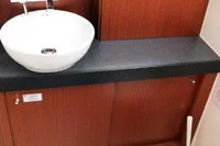 2017 Hanse 455 yacht bathroom with modern sink and wooden cabinetry.