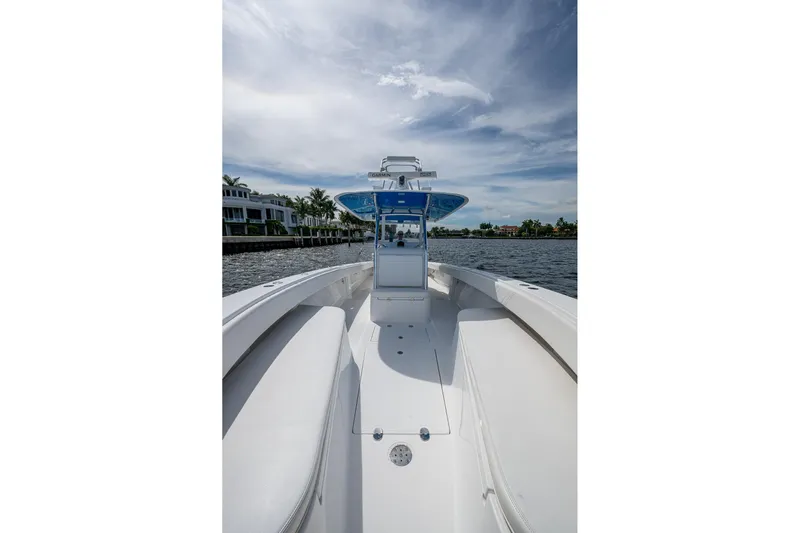  Yacht Photos Pics 2015 Bahama 41 boat on water with clear sky and waterfront homes.