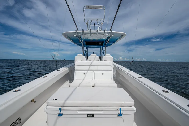  Yacht Photos Pics 2015 Bahama 41 boat on open water, featuring spacious deck and fishing rods.