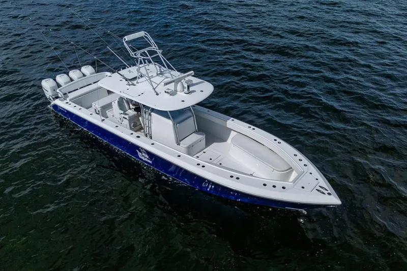  Yacht Photos Pics 2015 Bahama 41 boat on water, featuring sleek design and multiple outboard engines.