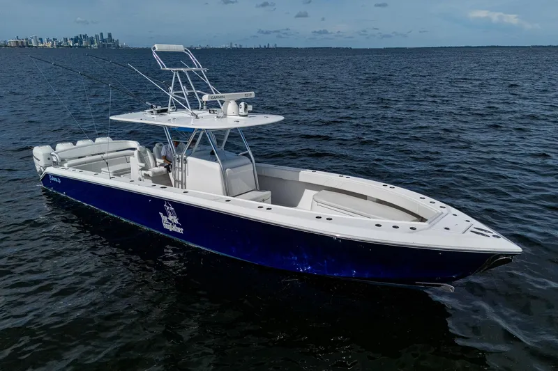  Yacht Photos Pics 2015 Bahama 41 boat on open water, city skyline in background.