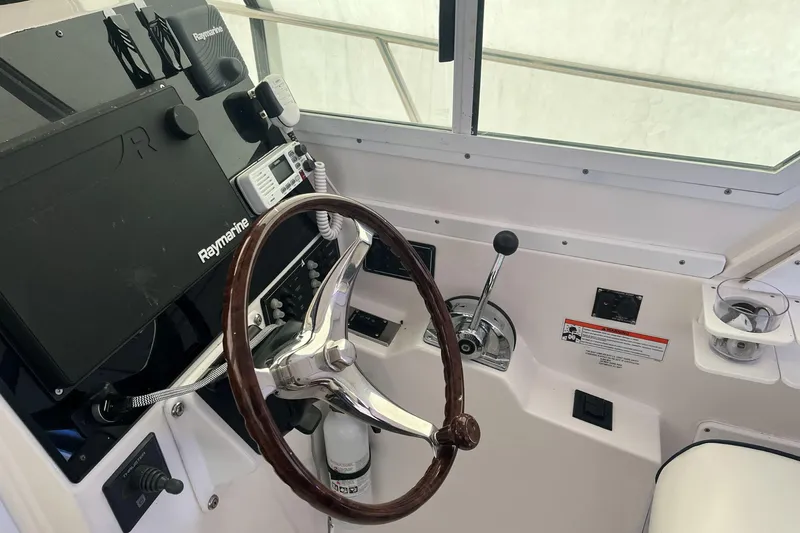  Yacht Photos Pics 2008 Albin 28 Tournament Express helm with Raymarine electronics and wooden steering wheel.