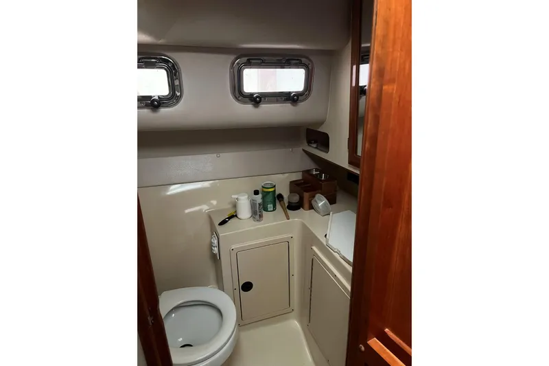  Yacht Photos Pics Bathroom interior of 2008 Albin 28 Tournament Express boat, featuring compact design and porthole windows.
