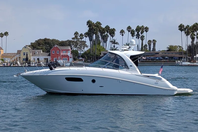 Fansea Yacht Photos Pics 2009 Sea Ray 350 Sundancer yacht cruising on a scenic waterway with palm trees.