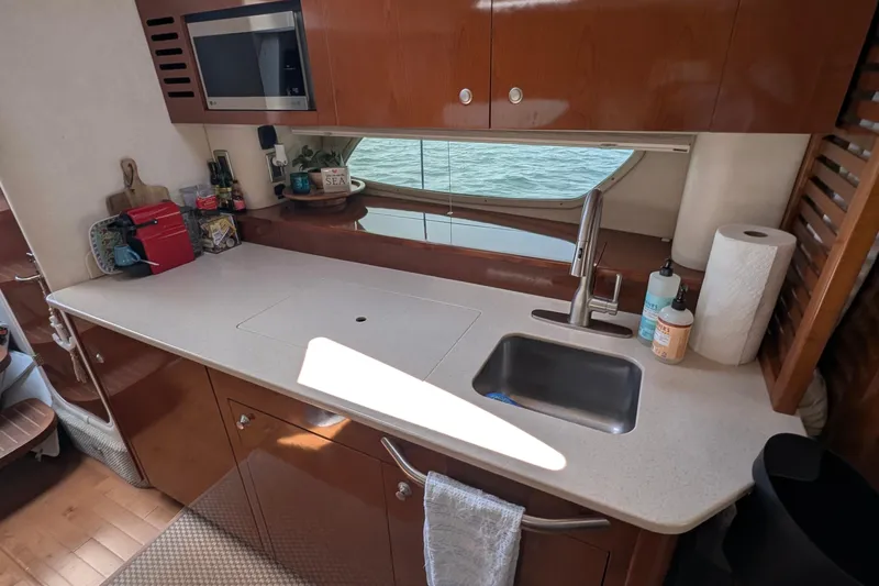 Fansea Yacht Photos Pics 2009 Sea Ray 350 Sundancer yacht kitchen with sink, countertop, and microwave.