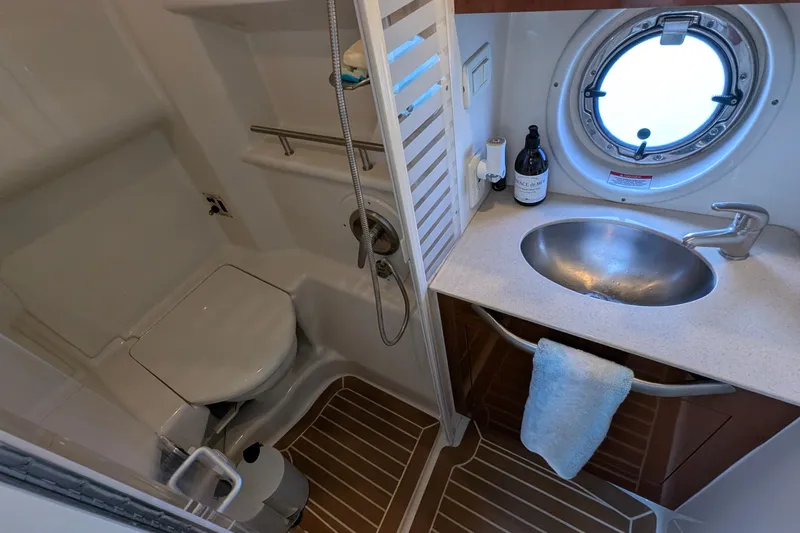 Fansea Yacht Photos Pics 2009 Sea Ray 350 Sundancer bathroom with sink, toilet, and porthole window.