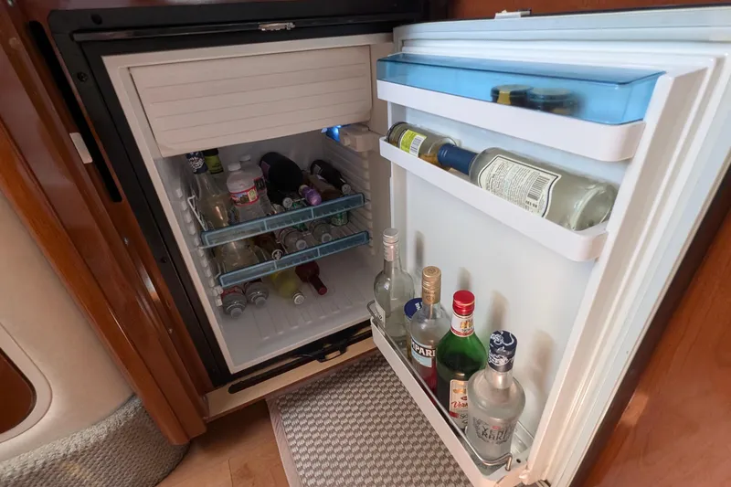 Fansea Yacht Photos Pics Open fridge on 2009 Sea Ray 350 Sundancer yacht, stocked with various beverages.