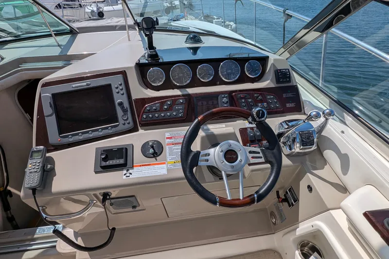 Fansea Yacht Photos Pics Cockpit of 2009 Sea Ray 350 Sundancer with steering wheel and navigation controls.
