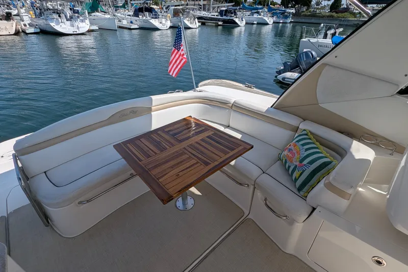Fansea Yacht Photos Pics 2009 Sea Ray 350 Sundancer yacht with elegant seating and wooden table, docked in marina.
