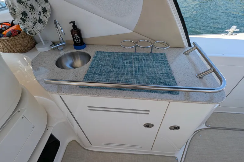 Fansea Yacht Photos Pics 2009 Sea Ray 350 Sundancer boat kitchenette with sink, faucet, and countertop accessories.