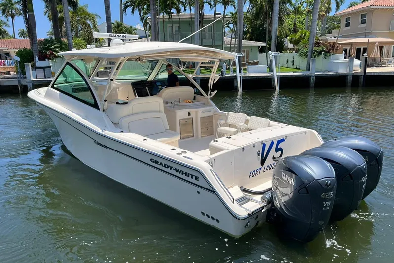 V5 Yacht Photos Pics 2019 Grady-White Freedom 375 boat with triple Yamaha engines, docked in a sunny marina.