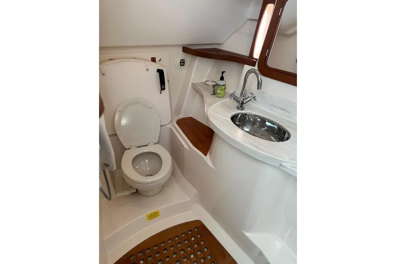 V5 Yacht Photos Pics 2019 Grady-White Freedom 375 boat bathroom with toilet, sink, and wooden accents.