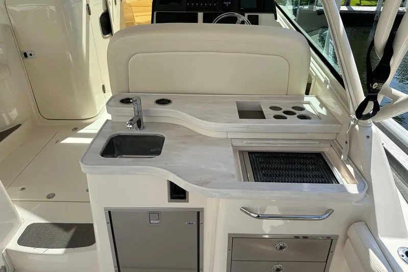 V5 Yacht Photos Pics 2019 Grady-White Freedom 375 boat interior with sink and storage area.