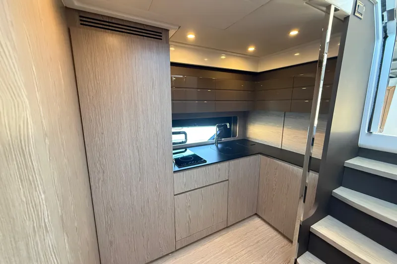  Yacht Photos Pics Modern kitchen interior of 2018 Azimut Atlantis 43 yacht with sleek cabinetry and appliances.