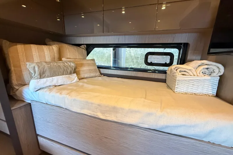  Yacht Photos Pics Cozy cabin interior of 2018 Azimut Atlantis 43 yacht with bed and window view.