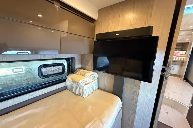  Yacht Photos Pics Interior of 2018 Azimut Atlantis 43 yacht with TV, window, and cozy bedding.