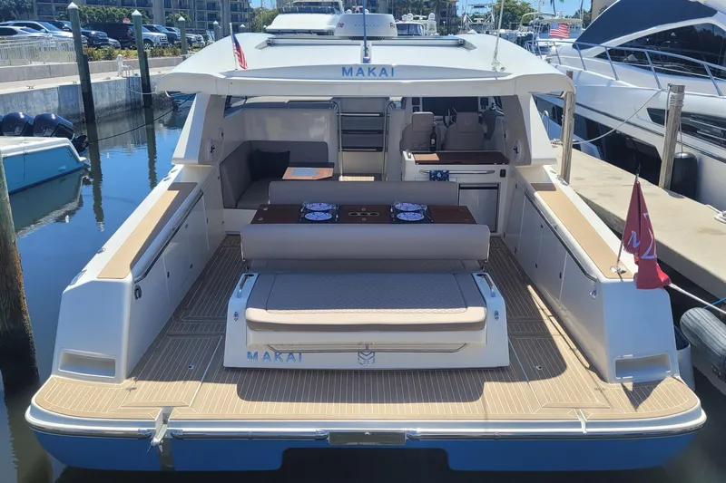  Yacht Photos Pics 2025 Makai M37 yacht docked, featuring spacious deck and seating area.