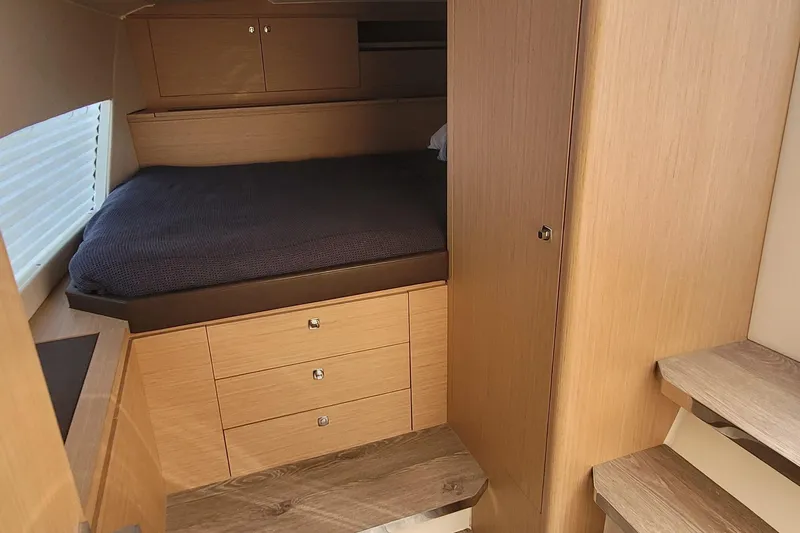  Yacht Photos Pics Cozy cabin interior of 2025 Makai M37 with wooden finish and comfortable bedding.