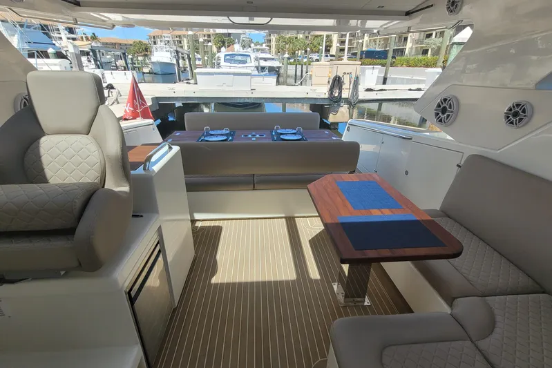  Yacht Photos Pics Luxurious interior of 2025 Makai M37 yacht with elegant seating and wooden table.