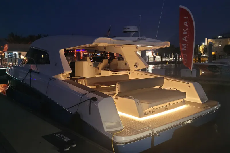  Yacht Photos Pics 2025 Makai M37 yacht illuminated at night, docked in a marina.