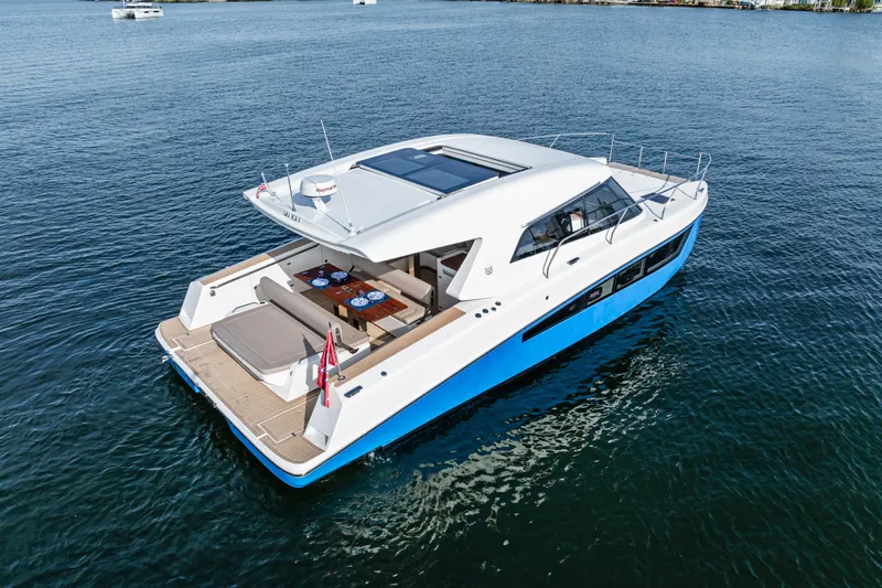  Yacht Photos Pics 2025 Makai M37 yacht on calm water, featuring sleek design and spacious deck.