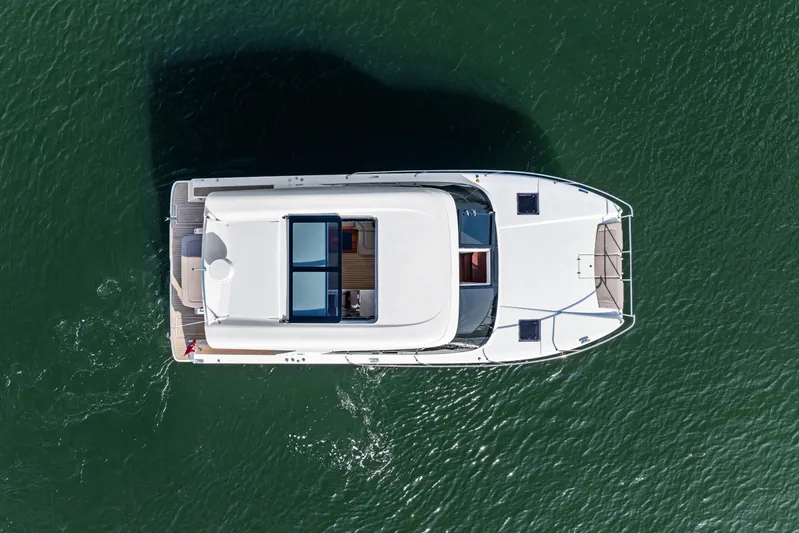  Yacht Photos Pics Overhead view of 2025 Makai M37 yacht on calm green water.