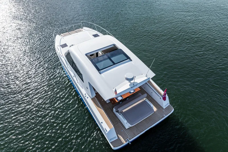  Yacht Photos Pics 2025 Makai M37 yacht cruising on calm waters, showcasing sleek design and spacious deck.