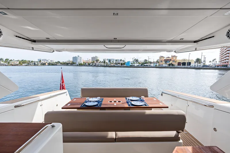  Yacht Photos Pics Luxury Makai M37 yacht interior with elegant dining setup, overlooking serene waterfront view.