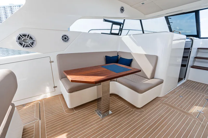  Yacht Photos Pics Luxurious interior of 2025 Makai M37 yacht with elegant seating and wooden table.