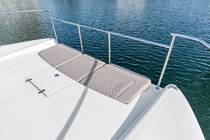  Yacht Photos Pics Luxury deck of 2025 Makai M37 yacht with cushioned seating by the water.