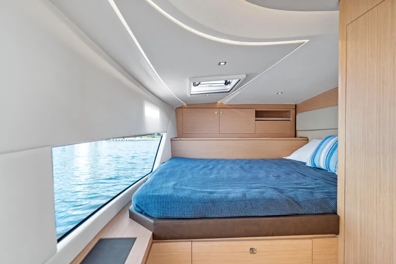  Yacht Photos Pics Luxurious cabin interior of 2025 Makai M37 yacht with large window and cozy bed.