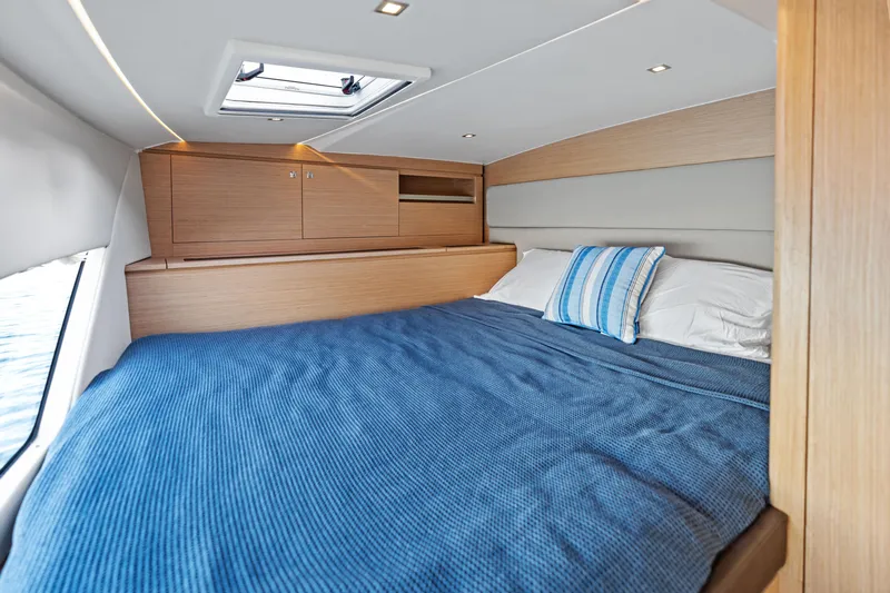  Yacht Photos Pics Luxurious cabin interior of 2025 Makai M37 yacht with cozy bed and skylight.